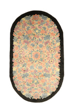 Load image into Gallery viewer, Vintage Chinese Art Deco rug, 83x49 inches (210x125 cm), featuring intricate floral patterns in pastel coral, blue, and mauve on an ivory background, framed by a bold black oval border.