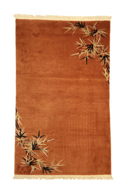 Antique Chinese Deco rug, 91x53 inches (230x135 cm), handwoven wool featuring elegant bamboo leaf sprays in black and gold on a rich terracotta background.