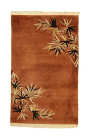 Antique Chinese Art Deco oval rug, 59x37 inches (150x94 cm), featuring burgundy flowers emerging from a sage green border into a pale gold field, creating a tranquil garden scene.